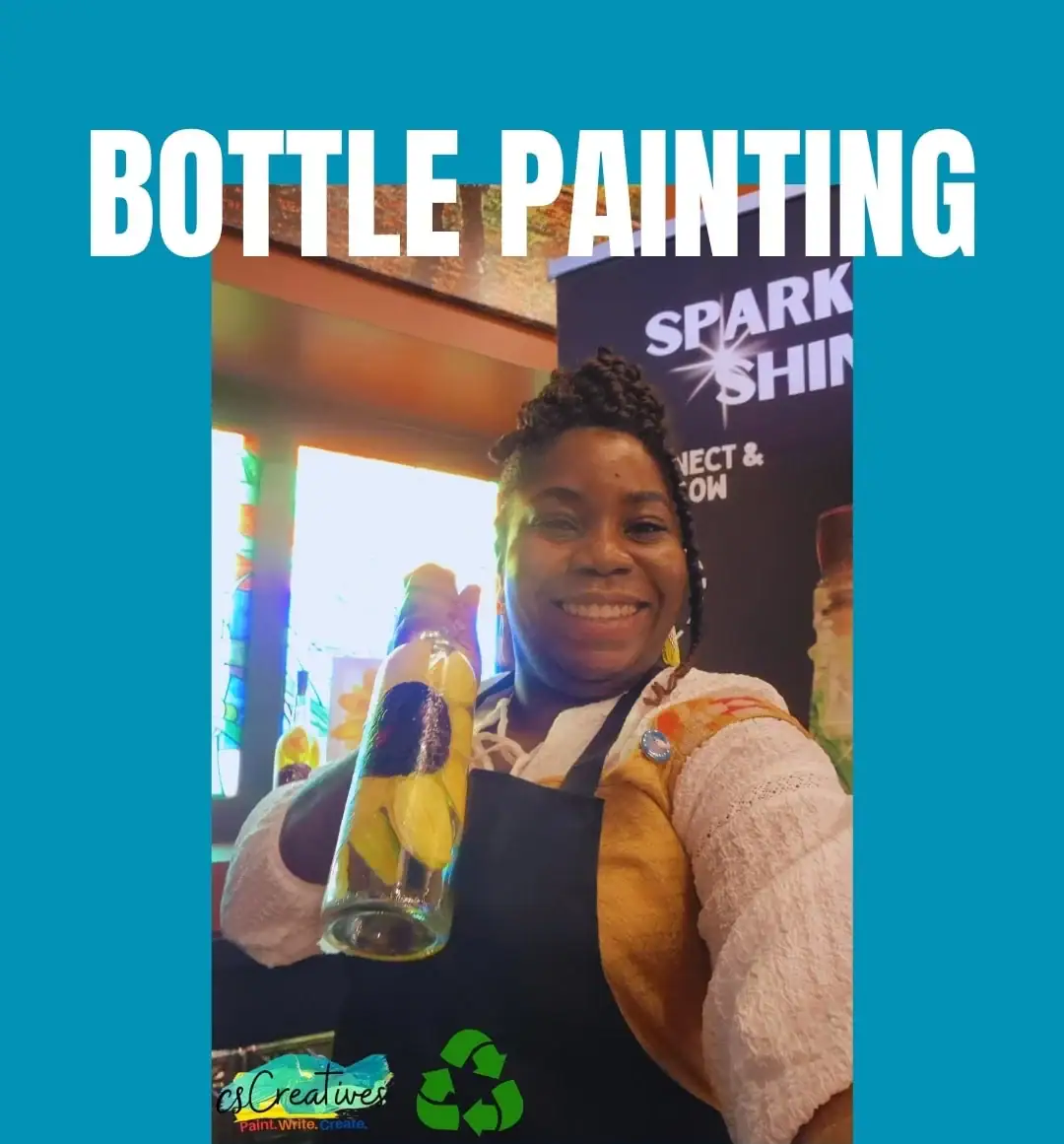 Woman holding a hand-painted recycled glass bottle at a csCreatives bottle painting experience promoting creativity and sustainability in Regina.